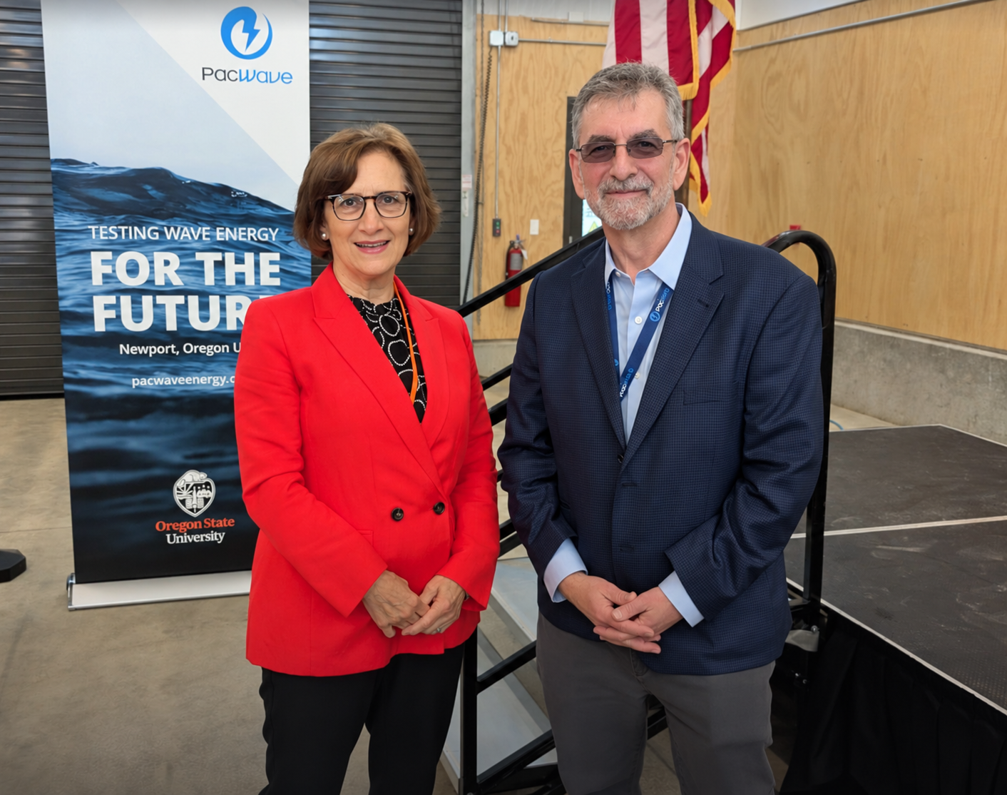 Suzanne Bonamici, U.S. representative for Oregon's 1st congressional district, with PacWave director Dan Hellin. Suzanne Bonamici, U.S. representative for Oregon's 1st congressional district, and PacWave director Dan Hellin smile in front of a podium and PacWave banner.